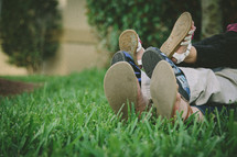 Mother, daughter, son's feet in grass 