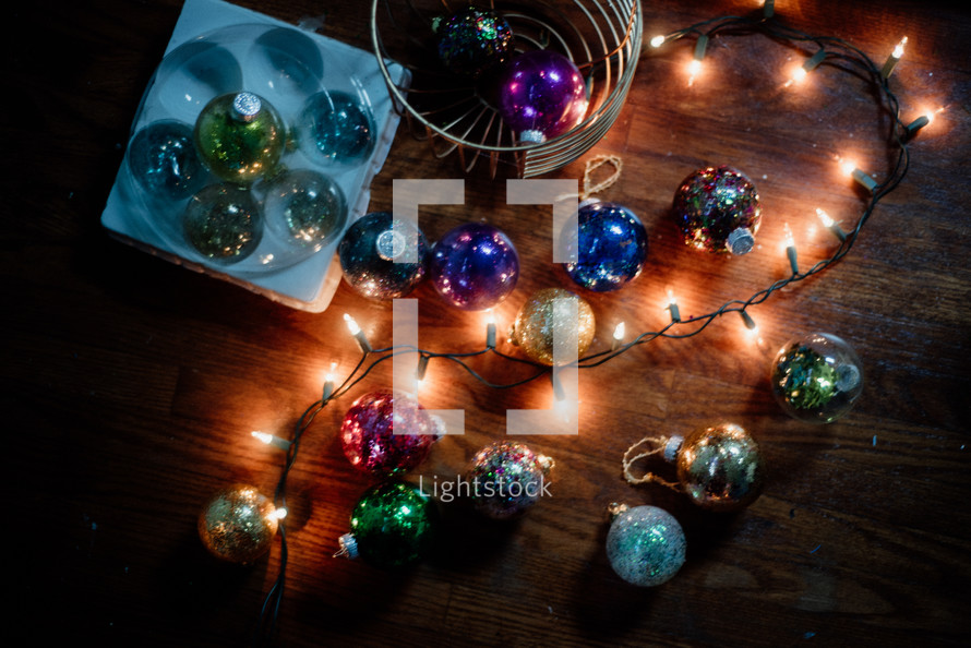 Christmas lights and ornaments on the floor 