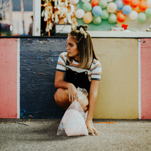 teen with cotton candy at a fair 