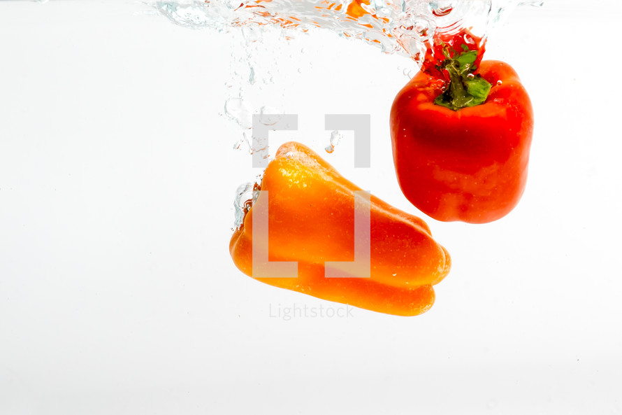 red and orange peppers under water