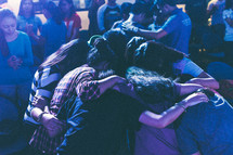 congregation hugging during a worship service 