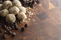 Coconut Chocolate Energy Balls on Wooden Butcher Block