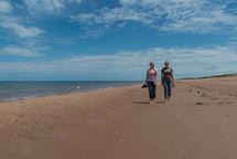 women walking on a beach 