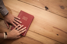 promise with hands on a Bible