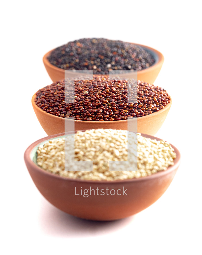 Three Bowls of Quinoa Varieties Isolated on a White Background