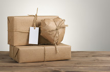 Packages wrapped in brown paper and tied with twine.