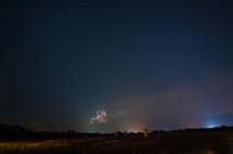 Lightning on the horizon of a night sky.