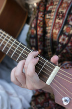 woman strumming a guitar 