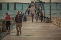 people on a beach pier 