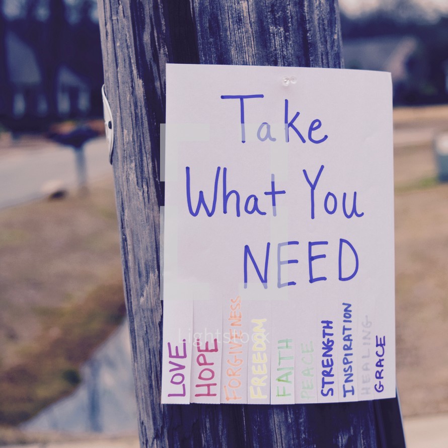 Take what you need flyer attached to a telephone pole 