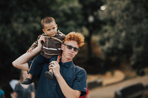 man with a toddler on his shoulders