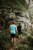 men hiking on a trail 