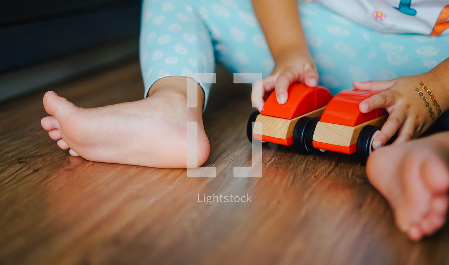 child playing with a toy car 