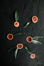 citrus fruit slices and green leaves 
