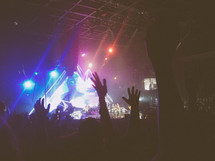raised hands at a concert