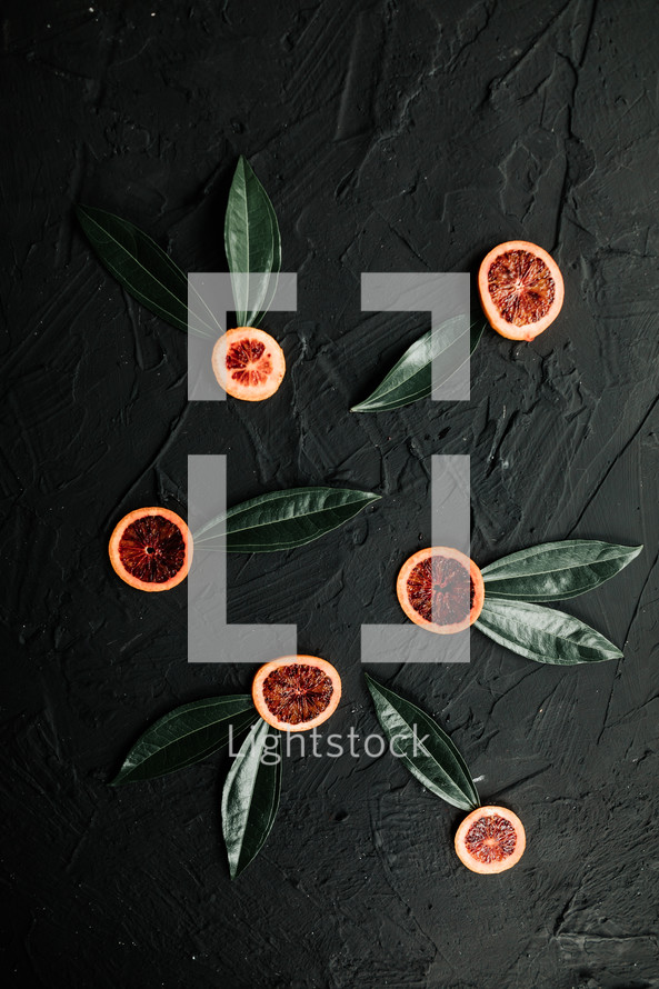 citrus fruit slices and green leaves 
