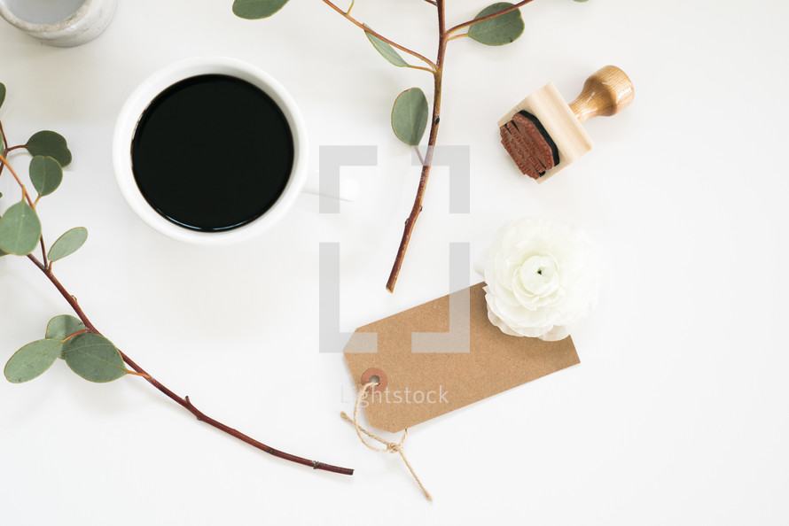 stamp, gift tag, eucalyptus twigs, coffee cup 