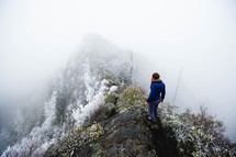 a woman climbing up an icy mountain 