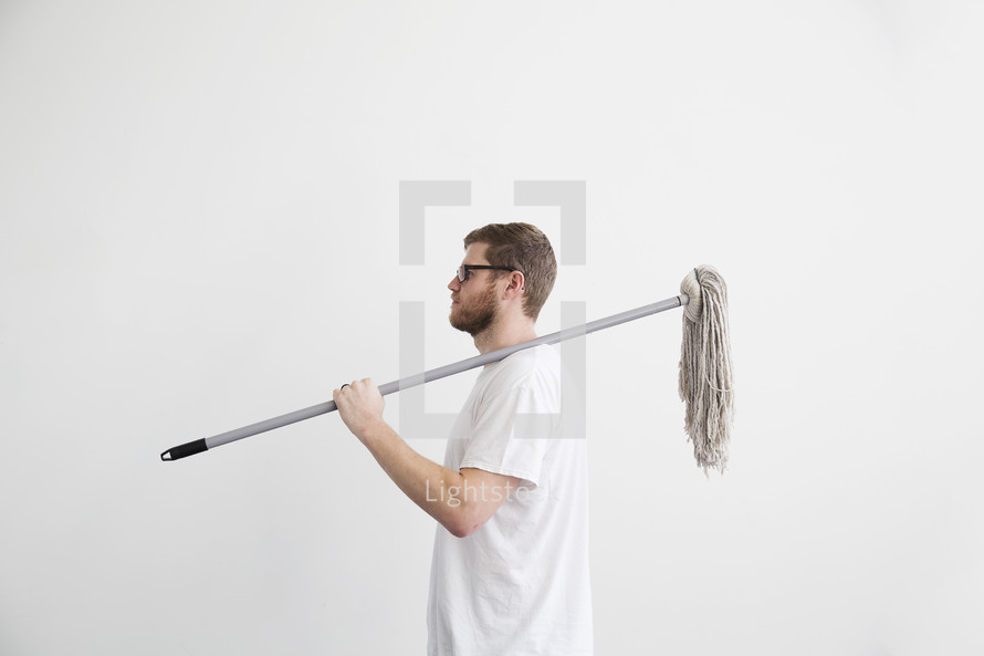 man with a mop over his shoulder 