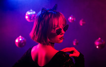  Portrait of young pretty woman in neon light. Pussy cat costume for halloween party. Sexy elegant lady with sunglasses and lace ears. High quality