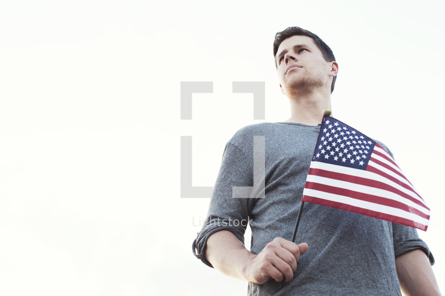 Man holding an American flag.