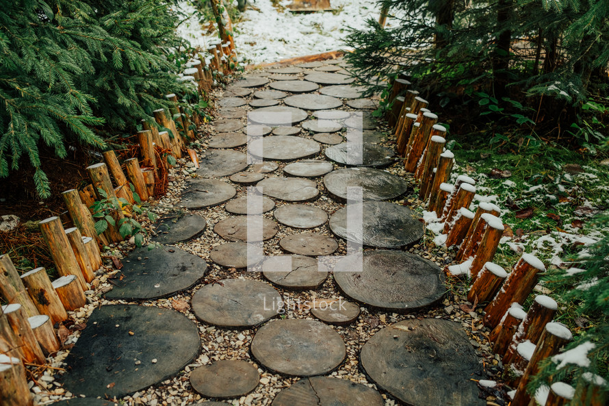 Creative idea for garden paths made of wood, log cabin. Winter nature. High quality photo