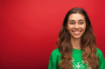 a headshot of a smiling woman in a Christmas shirt 