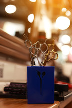 Professional hairdressing tools. Various steel scissors and combs, hairbrushes on wooden table on barbers workplace at barbershop salon. The concept of the hairdressing beauty industry. Copy space.