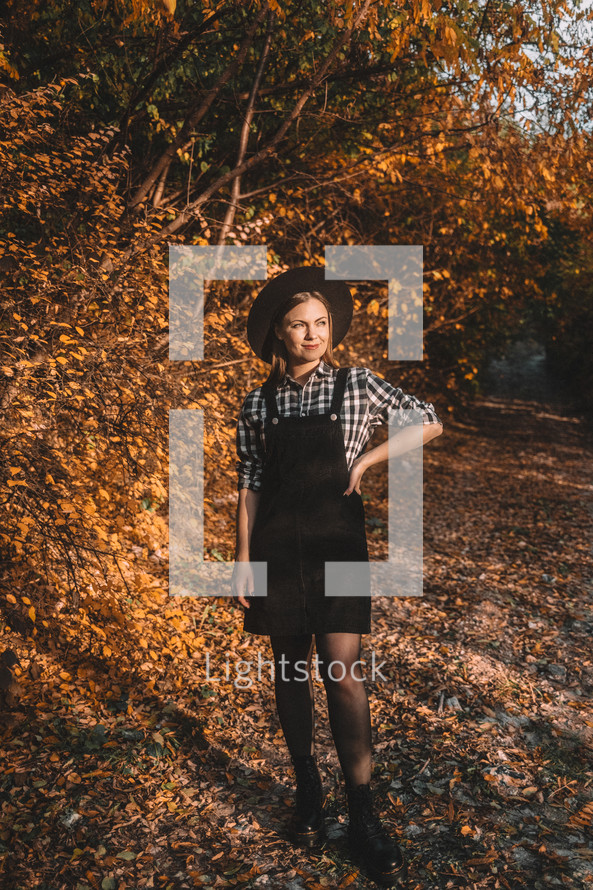 Hipster woman portrait, autumn park, beautiful golden nature. Lifestyle, hat.