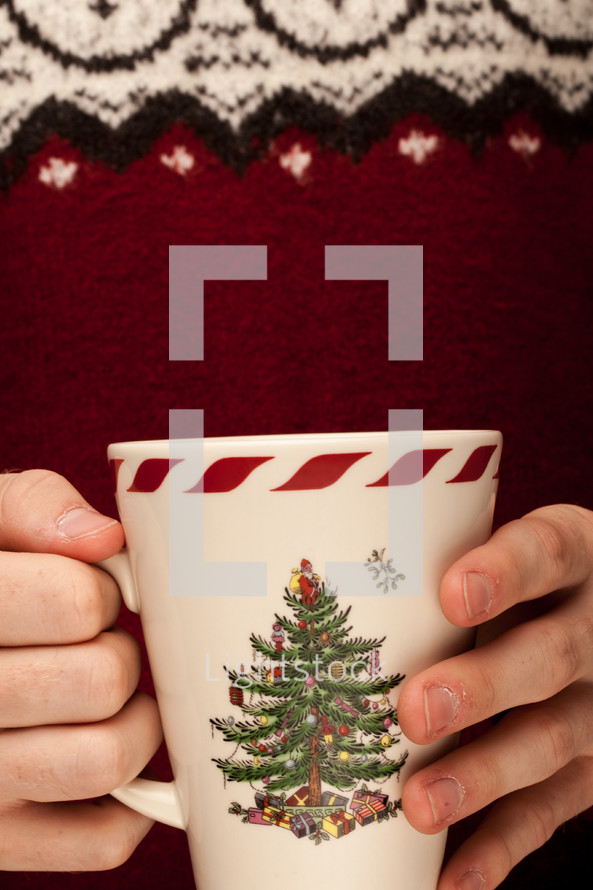 a man holding a Christmas mug