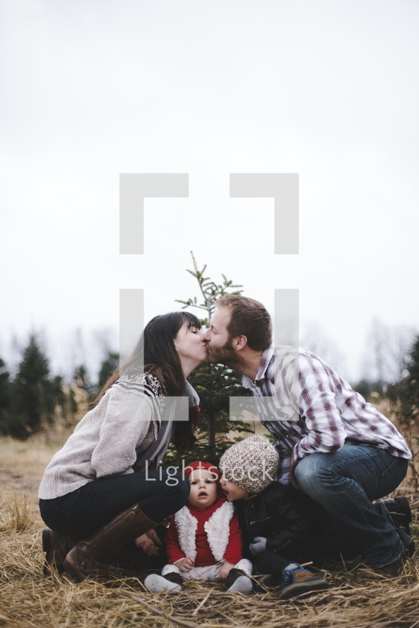 family Christmas portrait in a Christmas tree lot 