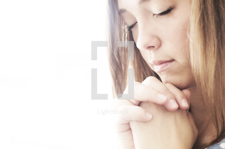 closeup of a woman in prayer.