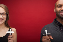 a man and woman holding candles at a candlelight service 