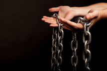 hands holding a chain