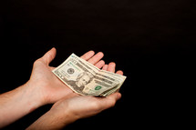 money in cupped hands 