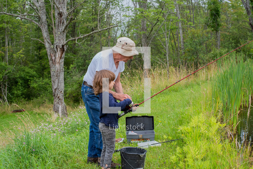 grandfather and granddaughter fishing together 