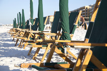 beach chairs and umbrellas in a row 