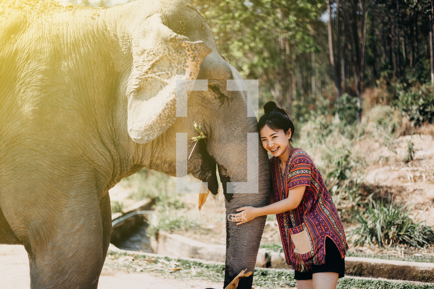 a woman hugging an elephant 