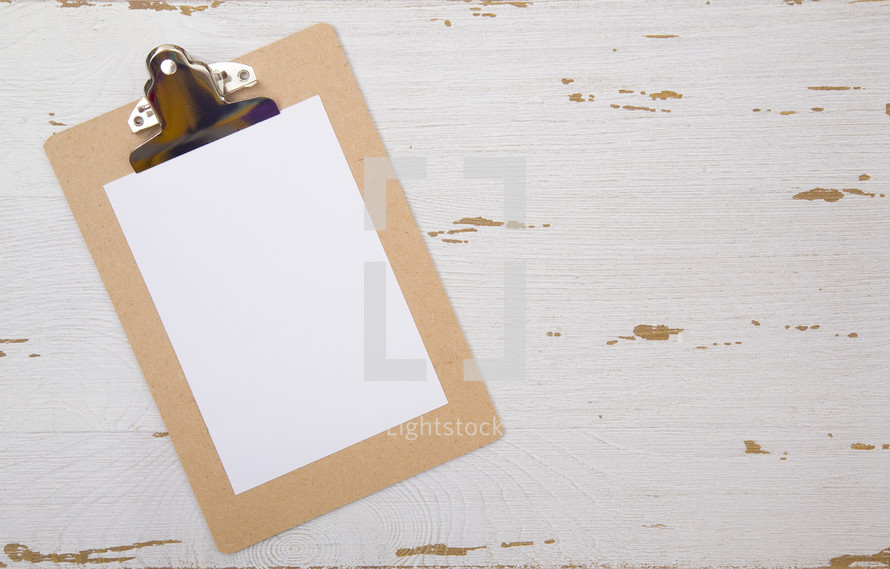 white paper on a clipboard 
