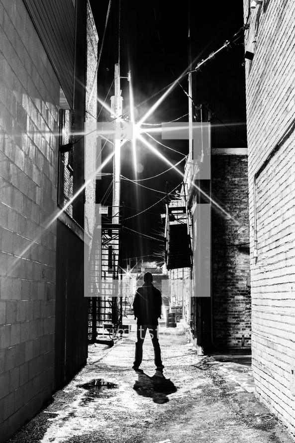 man standing in an alley
