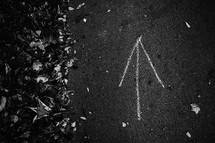 chalk arrow on asphalt 
