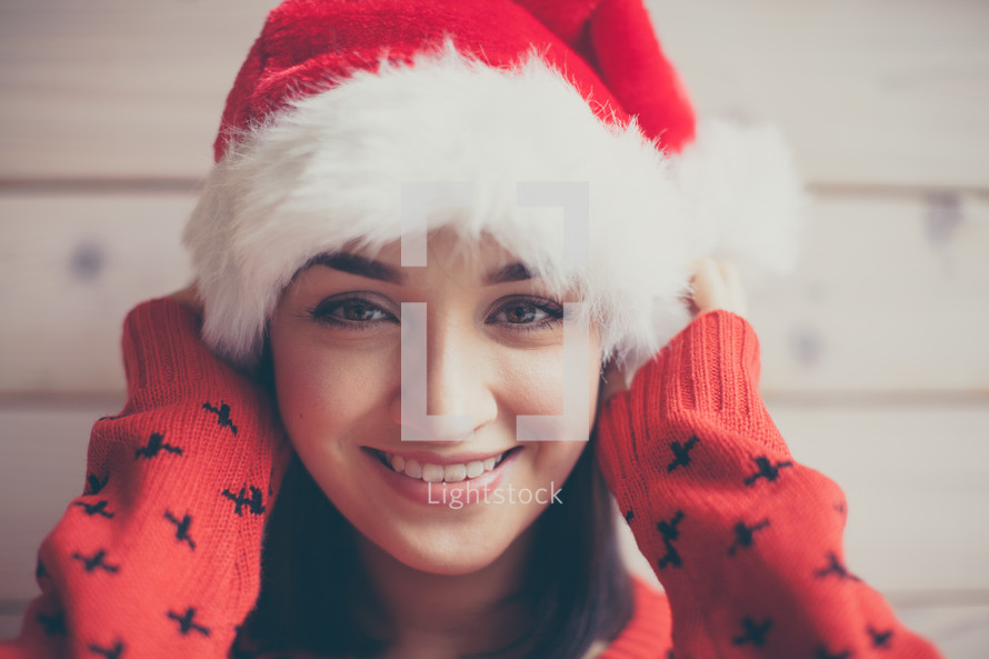 woman in a santa hat and Christmas sweater 