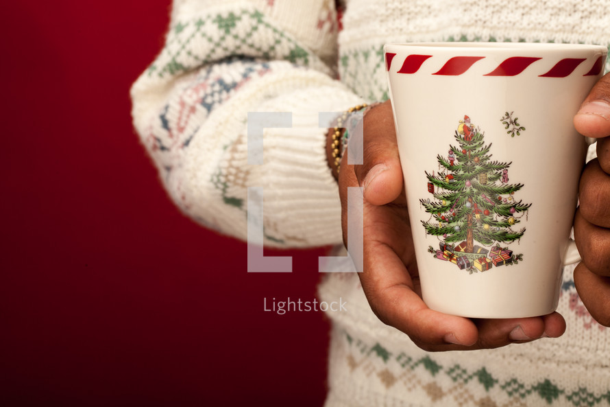 a man holding a Christmas mug 