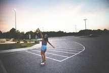 woman on a skateboard in a parking lot 