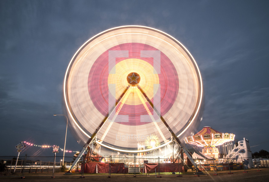 Ferris wheel in motion at an amusement park.