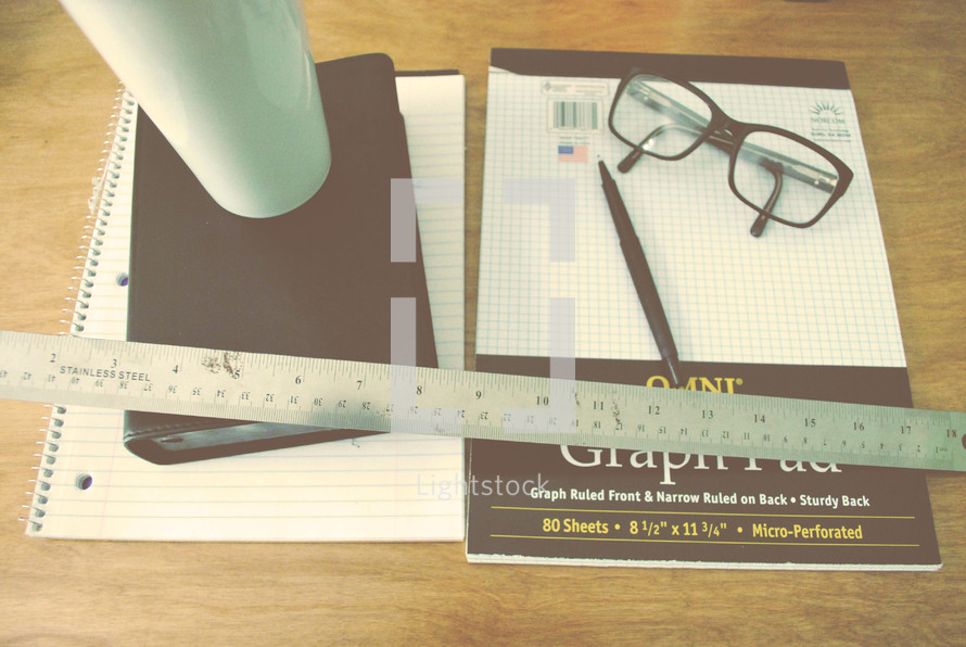 reading glasses and pencil on graph paper 