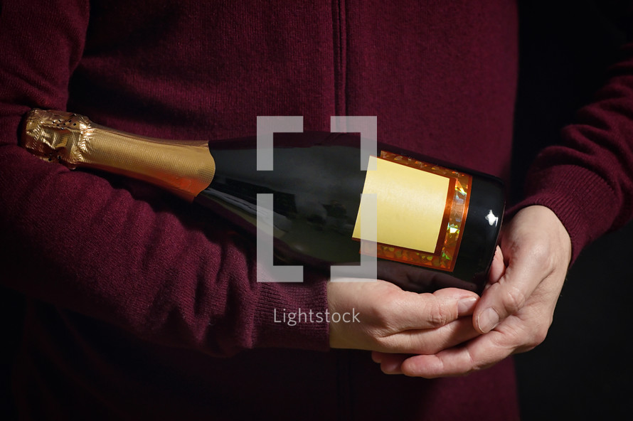 a man holding a champagne bottle 