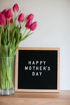 Happy Mother's day sign and tulips in a vase 