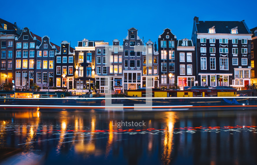 Houses and light trail reflections in the water in Amsterdam