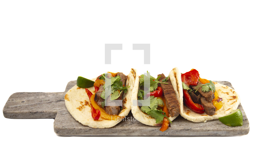 Beef Fajitas with Bell Peppers on a white background 